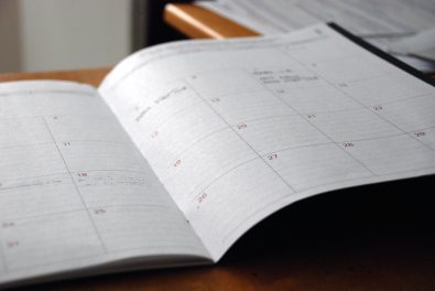 paper planner open to a blank calendar page