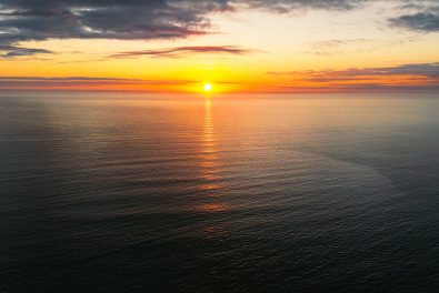 Sunset over body of water. Photo by Samuel Arkwright on Unsplash